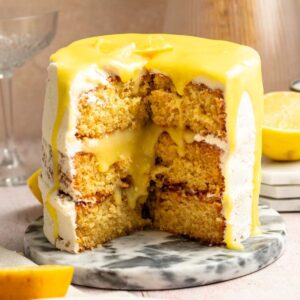 Slice missing from a lemon curd cake.