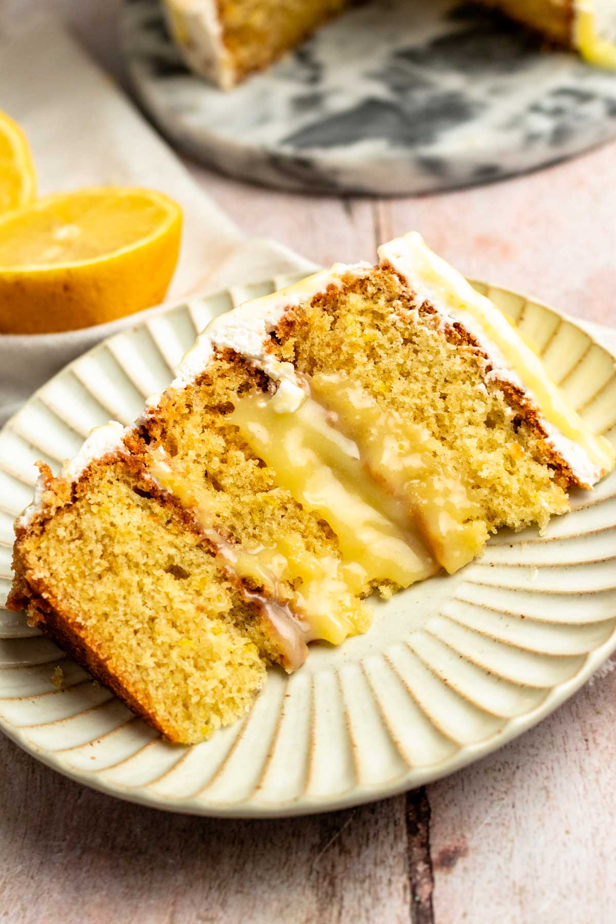 Slice of a lemon curd cake on a plate.