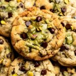 Top of pistachio chocolate chip cookies with pistachio cream.