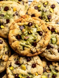Top of pistachio chocolate chip cookies with pistachio cream.