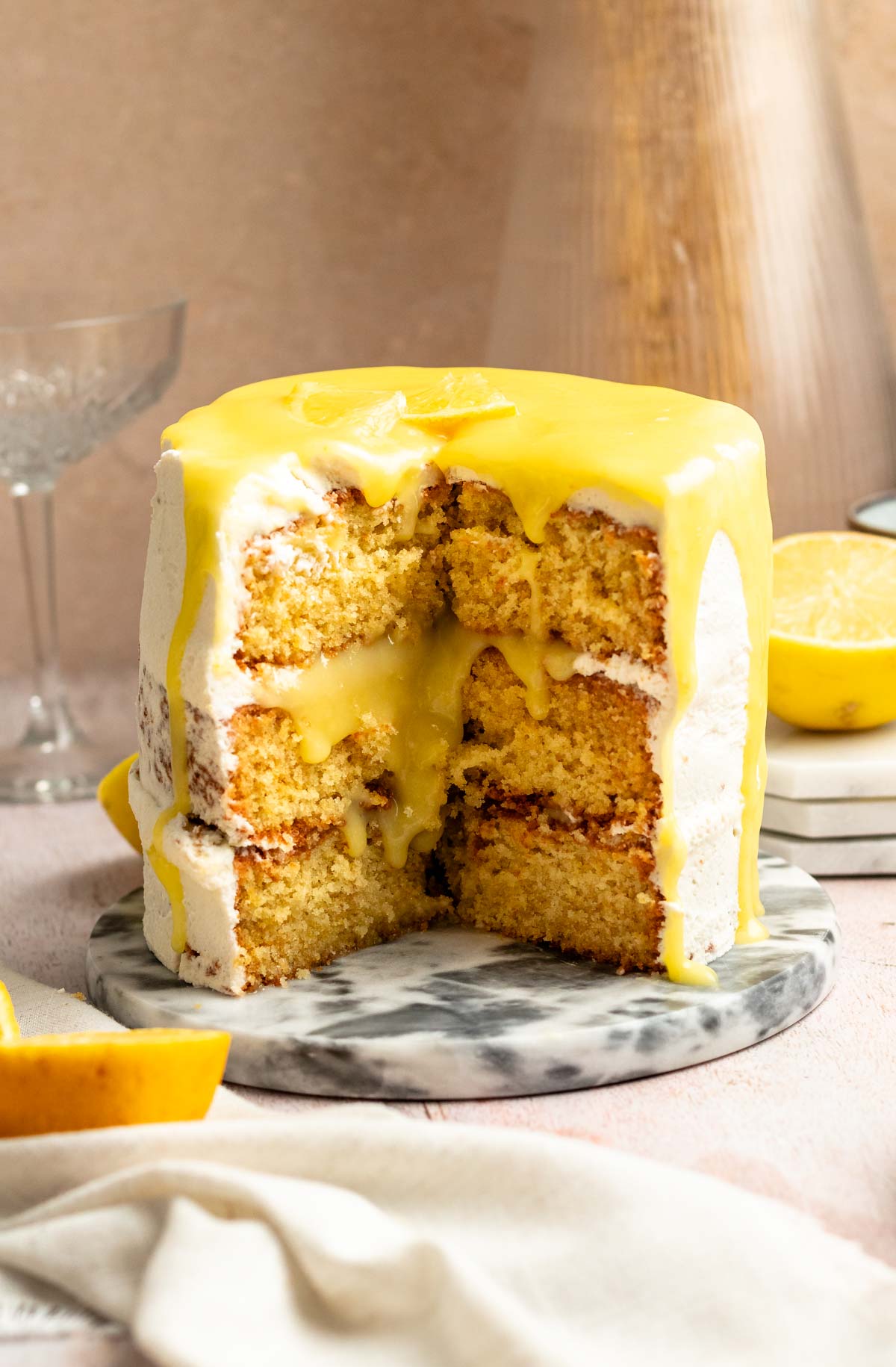 Slice missing from a lemon curd cake.