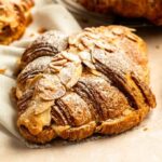 Close up shot of almond croissants with powdered sugar.