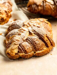 Close up shot of almond croissants with powdered sugar.