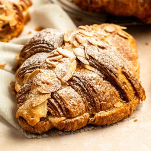 Close up shot of almond croissants with powdered sugar.