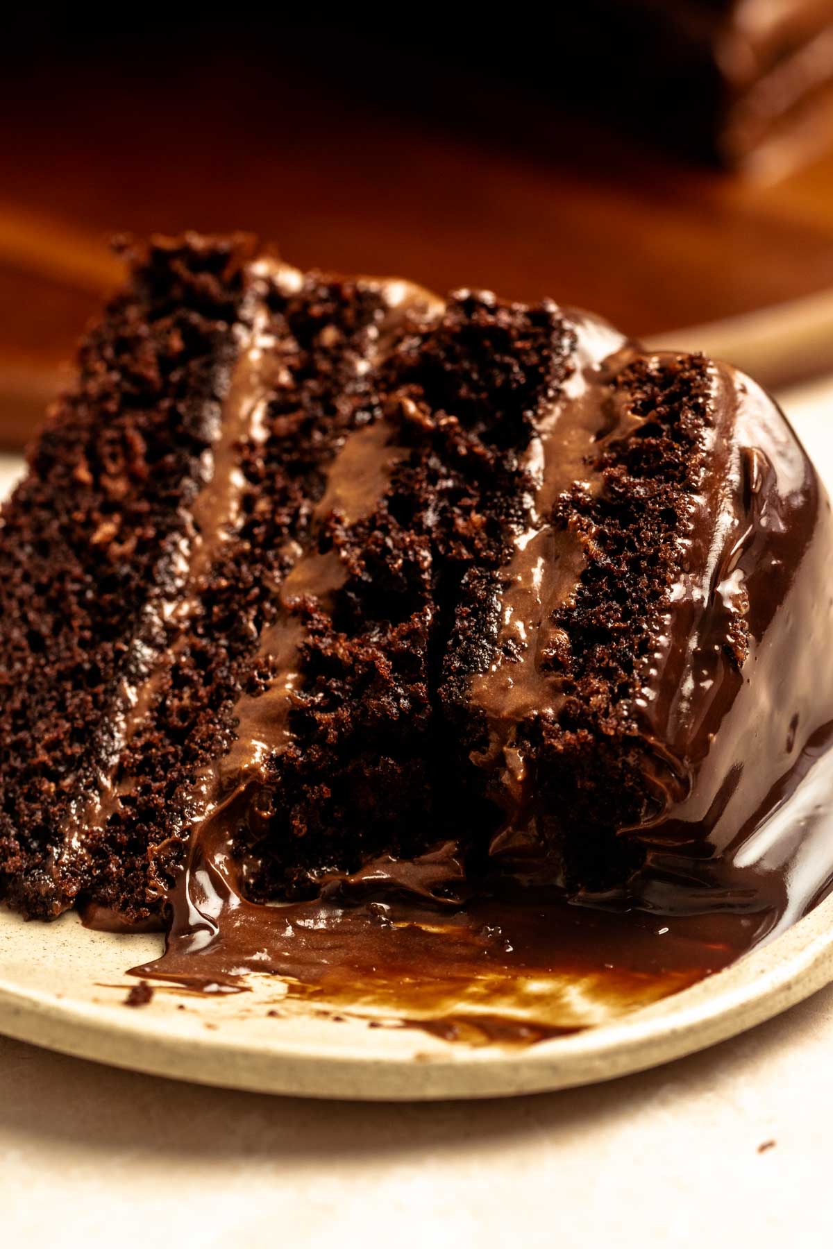 Bite missing from a slice of chocolate cake with chocolate mousse.