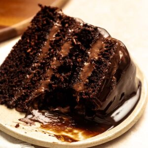 Bite missing from a slice of chocolate cake with chocolate mousse.