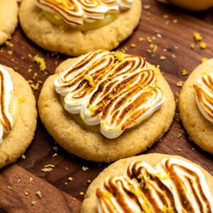 Lemon meringue pie cookies on a wooden board.