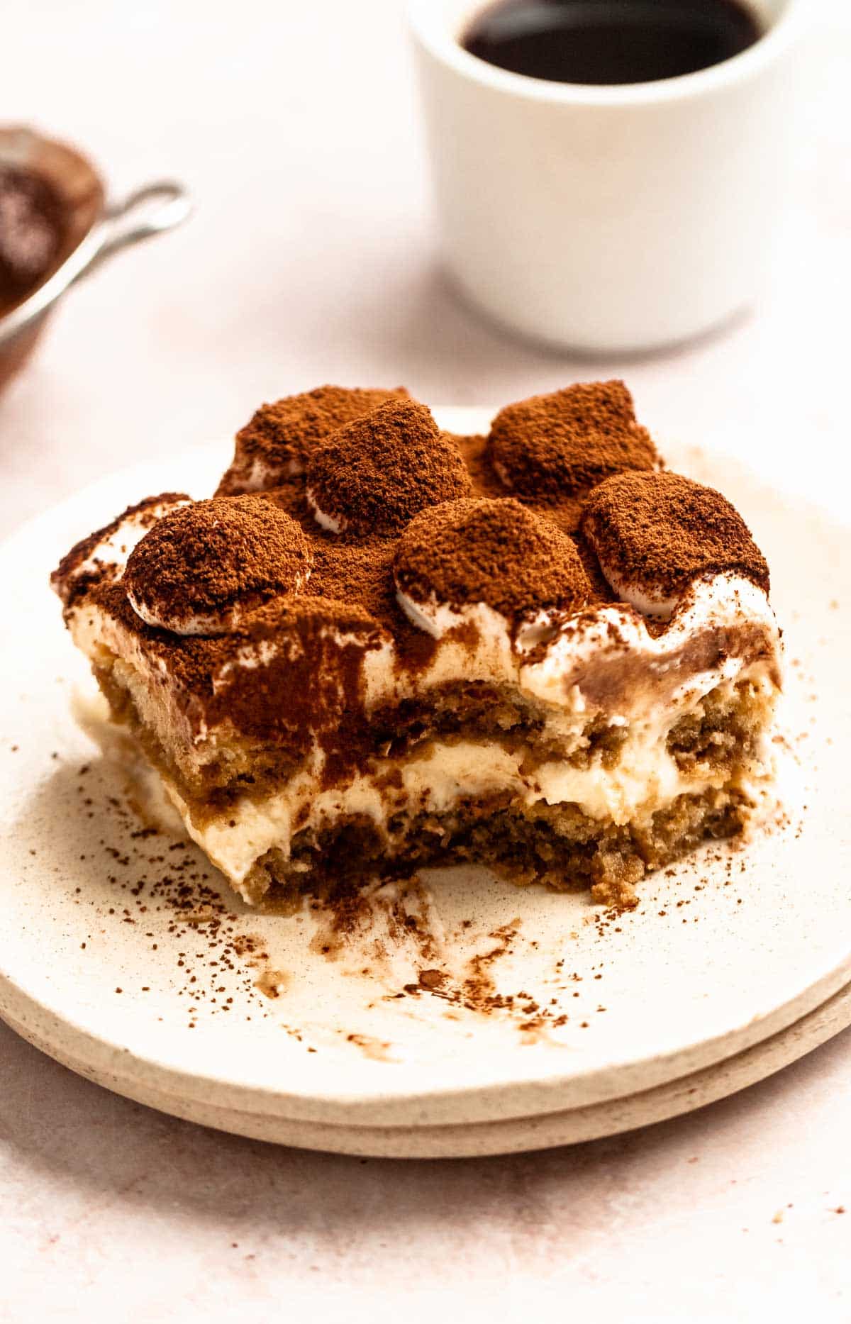 Bite missing from a slice of Italian tiramisu.