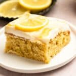 Slice of lemon sheet cake on a cake plate.