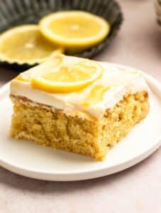 Slice of lemon sheet cake on a cake plate.