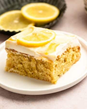 Slice of lemon sheet cake on a cake plate.