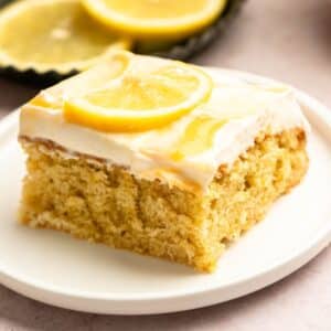 Slice of lemon sheet cake on a cake plate.