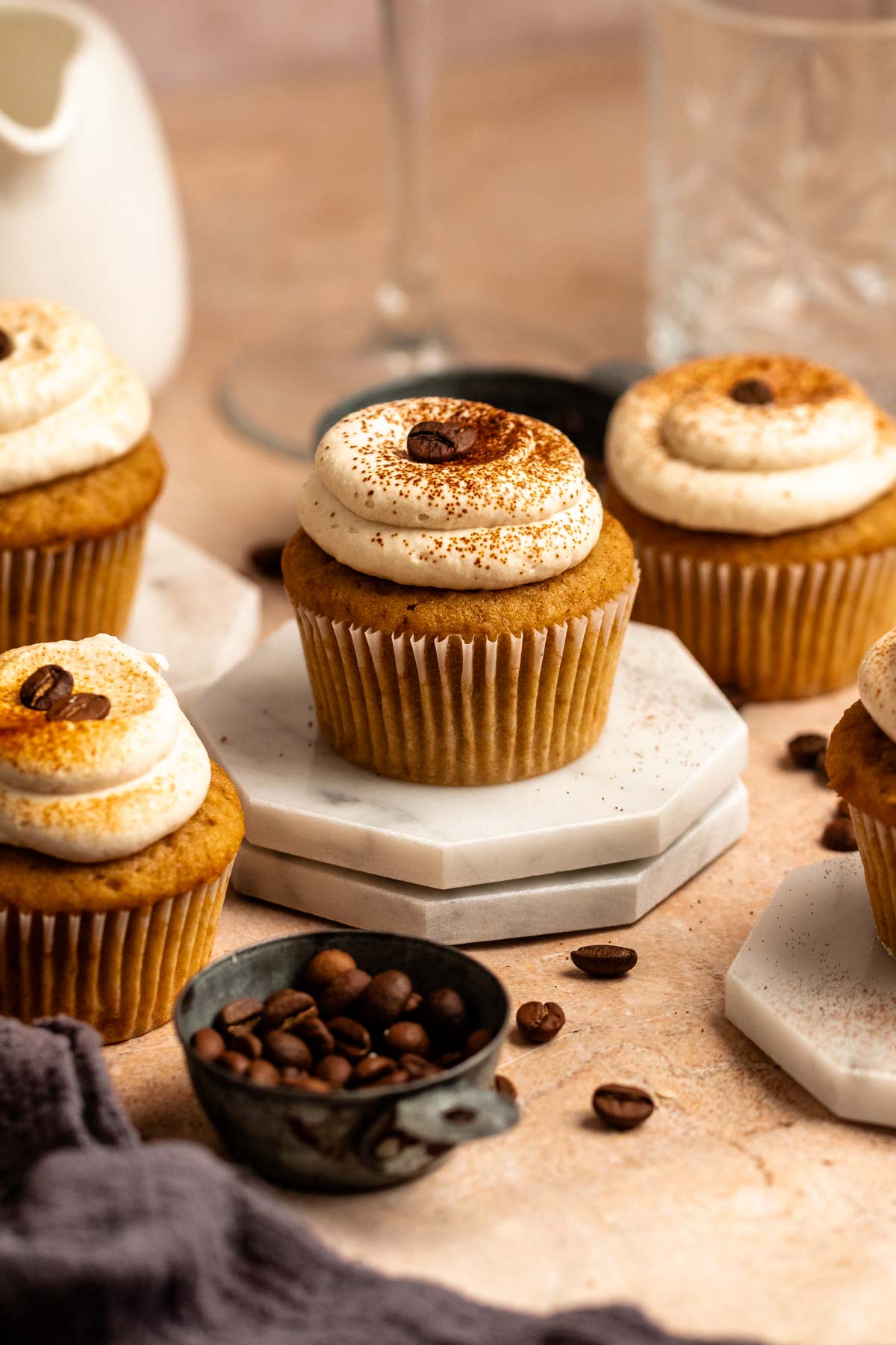 Coffee cupcake on a stack of two mini cake boards.