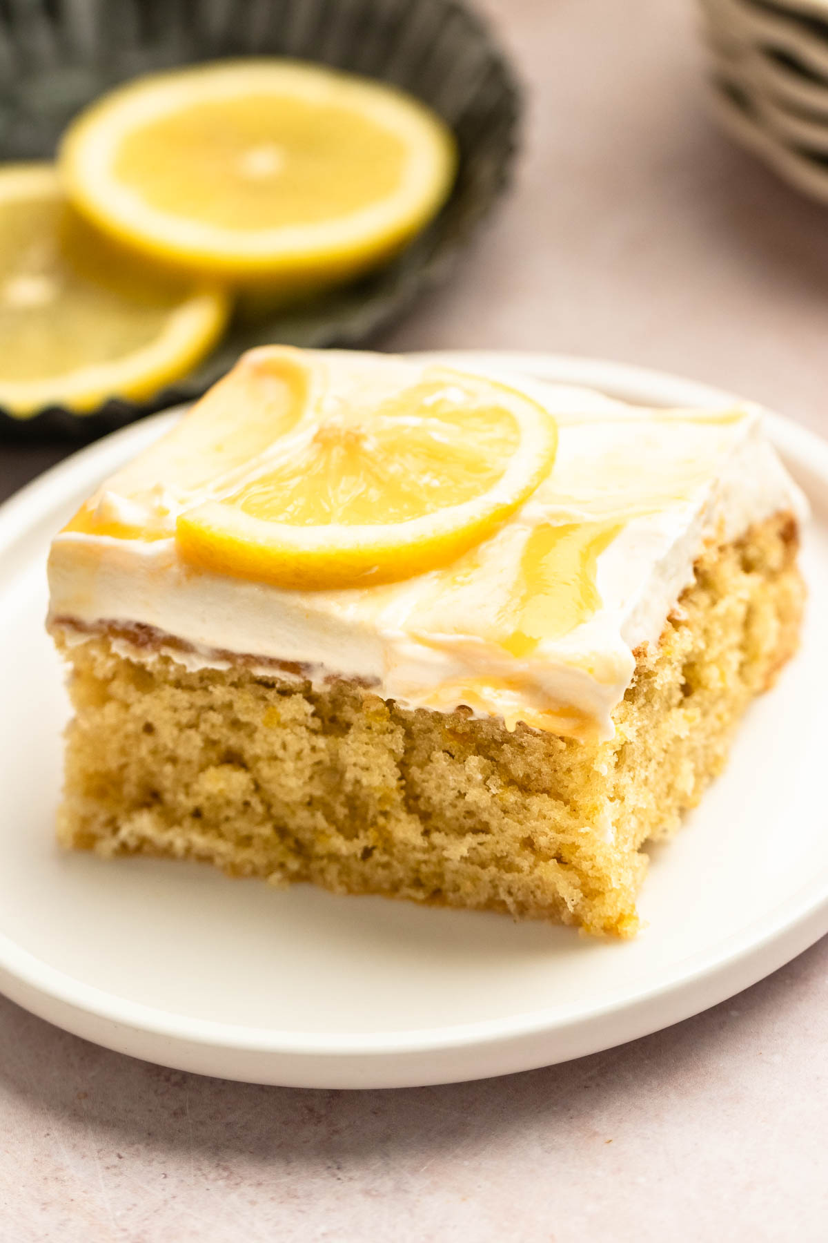 Slice of lemon sheet cake on a plate.