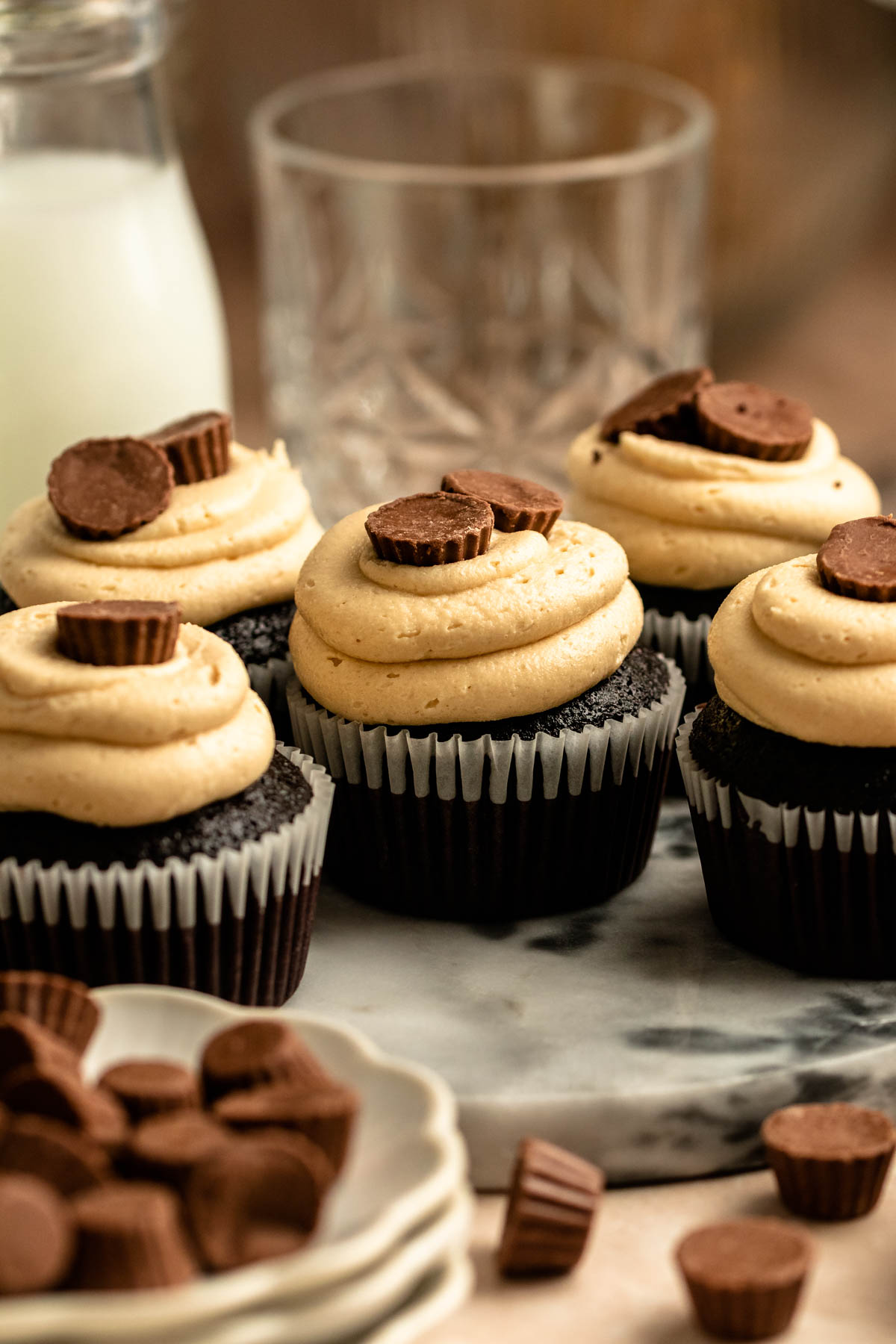 Reeses peanut butter chocolate cupcakes on a cake plate.