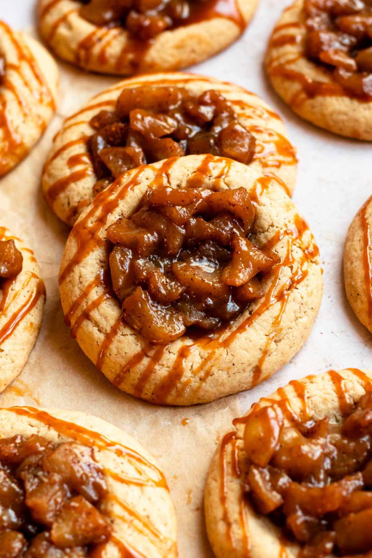 Apple pie cookies with a drizzle of caramel sauce.