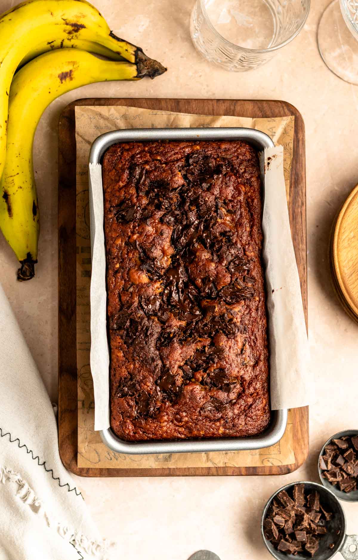 Top of a loaf of chocolate chunk banana bread in a pan.