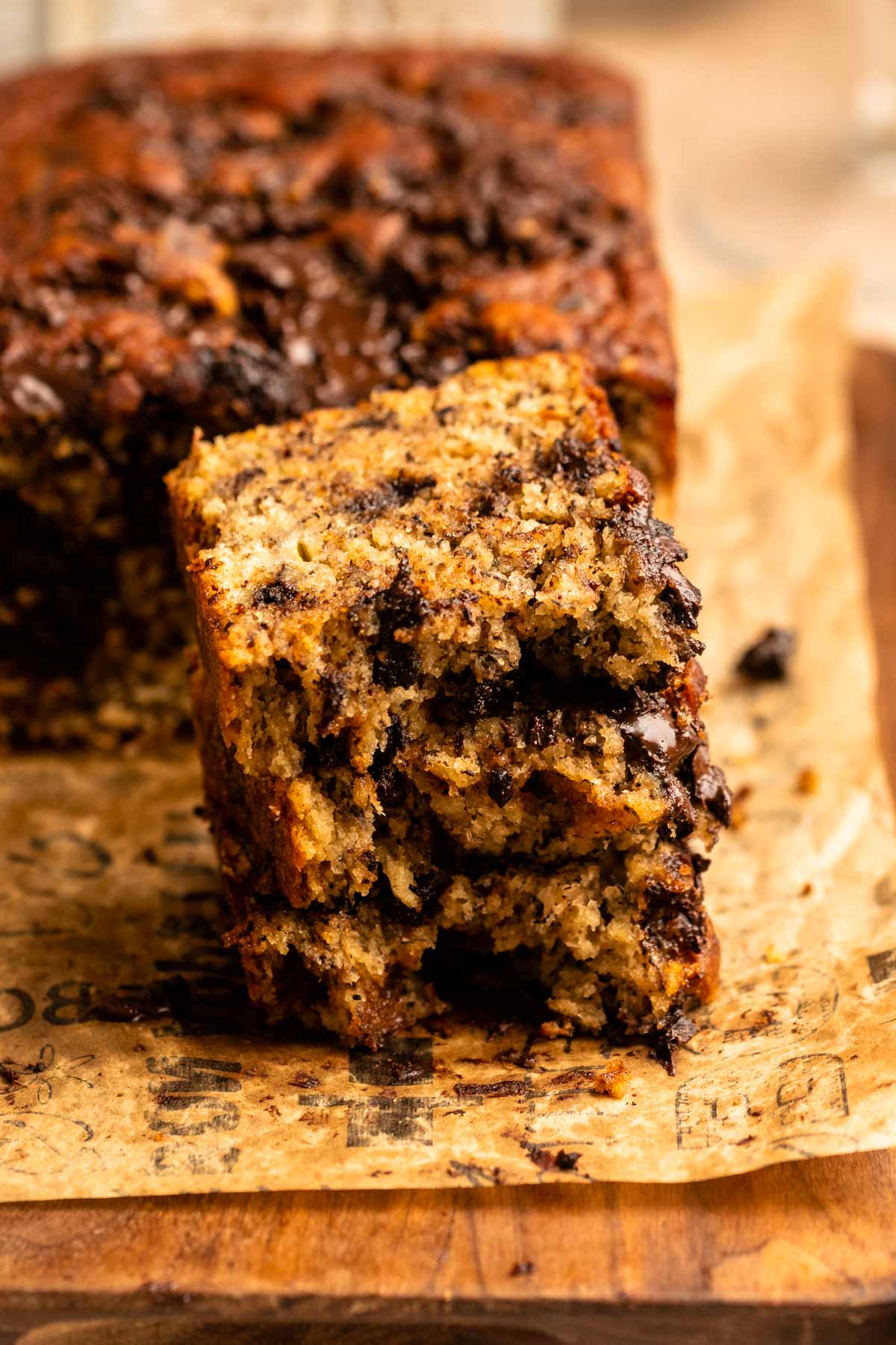 Stack of chocolate chunk banana bread slices cut in half.