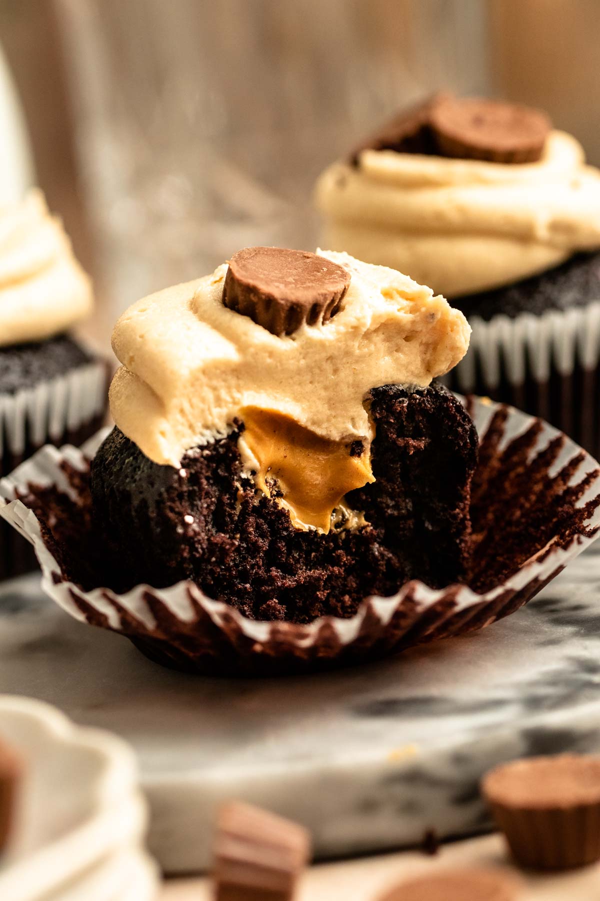 Bite missing from a reeses cup cupcakes.