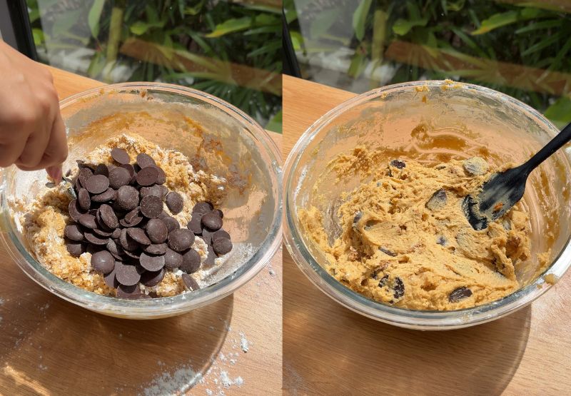 Using a silicone spatula to fold chocolate chips into the Biscoff cookie dough until just combined.