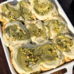 Top of pistachio cinnamon rolls in a pan.