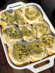 Top of pistachio cinnamon rolls in a pan.