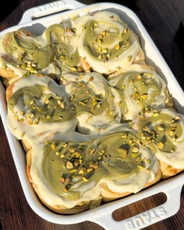 Top of pistachio cinnamon rolls in a pan.