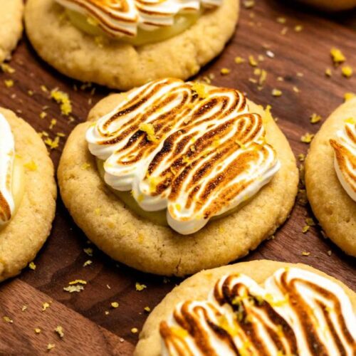 Lemon meringue pie cookies on a wooden board.