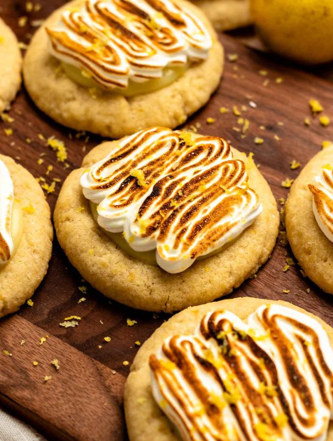 Lemon meringue pie cookies on a wooden board.