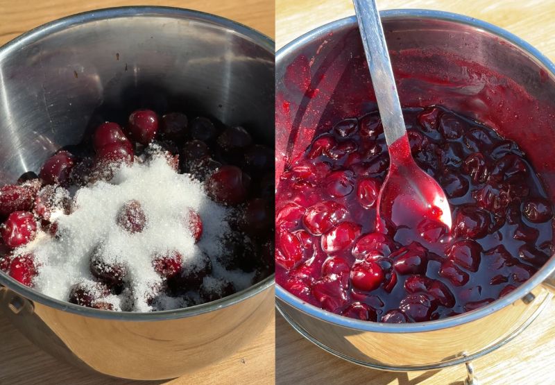 Fresh halved cherries tossed with sugar, lemon juice, and cornstarch in a glass mixing bowl.