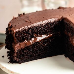 Chocolate Brooklyn blackout cake sliced open on a white cake plate.