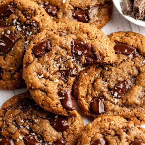 Top of coffee cookies with the top one with a bite missing.