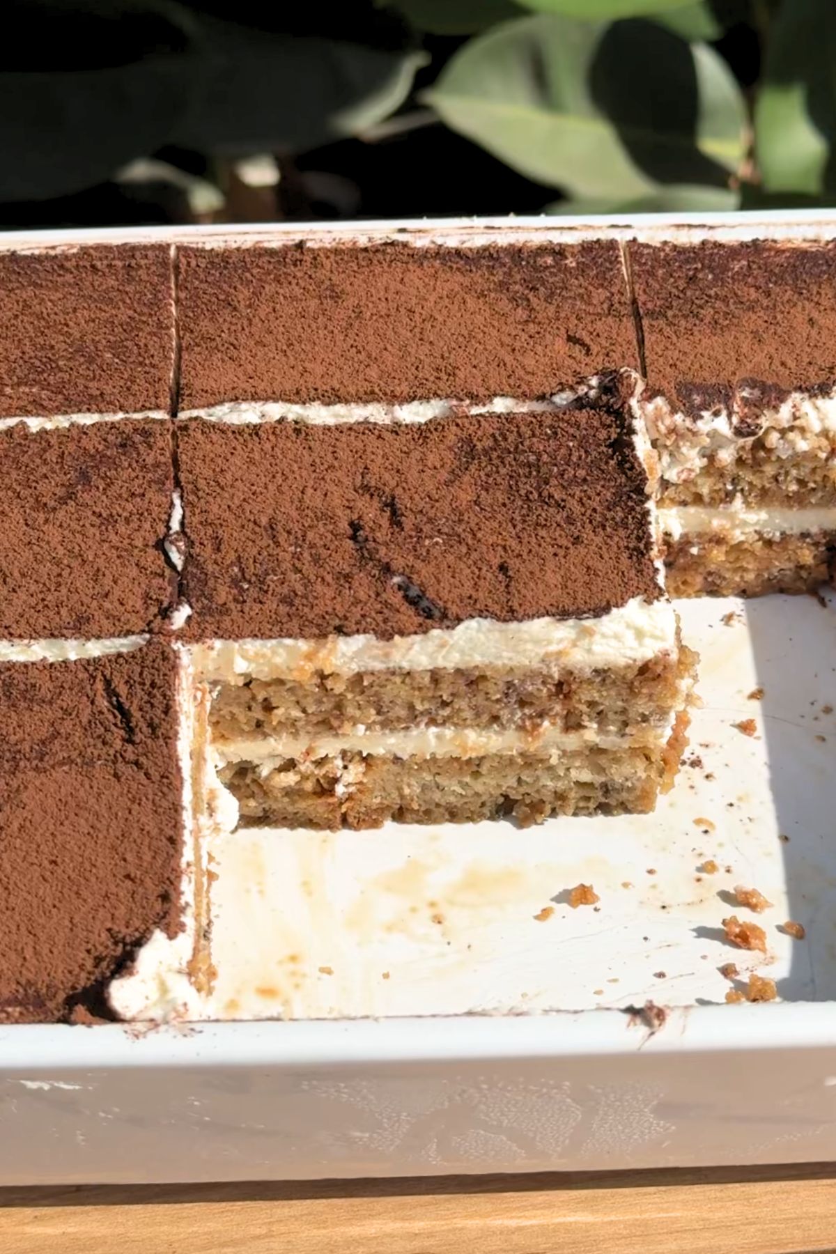 Slice missing from a banana bread tiramisu.