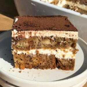 Slice of banana bread tiramisu on a white plate.