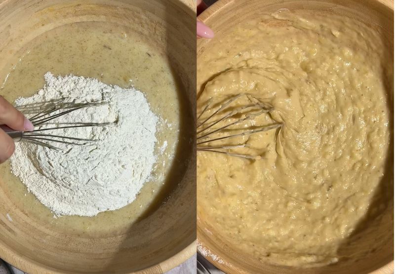 Flour added on top of the wet ingredients in a wooden bowl, and being whisked into a smooth batter.
