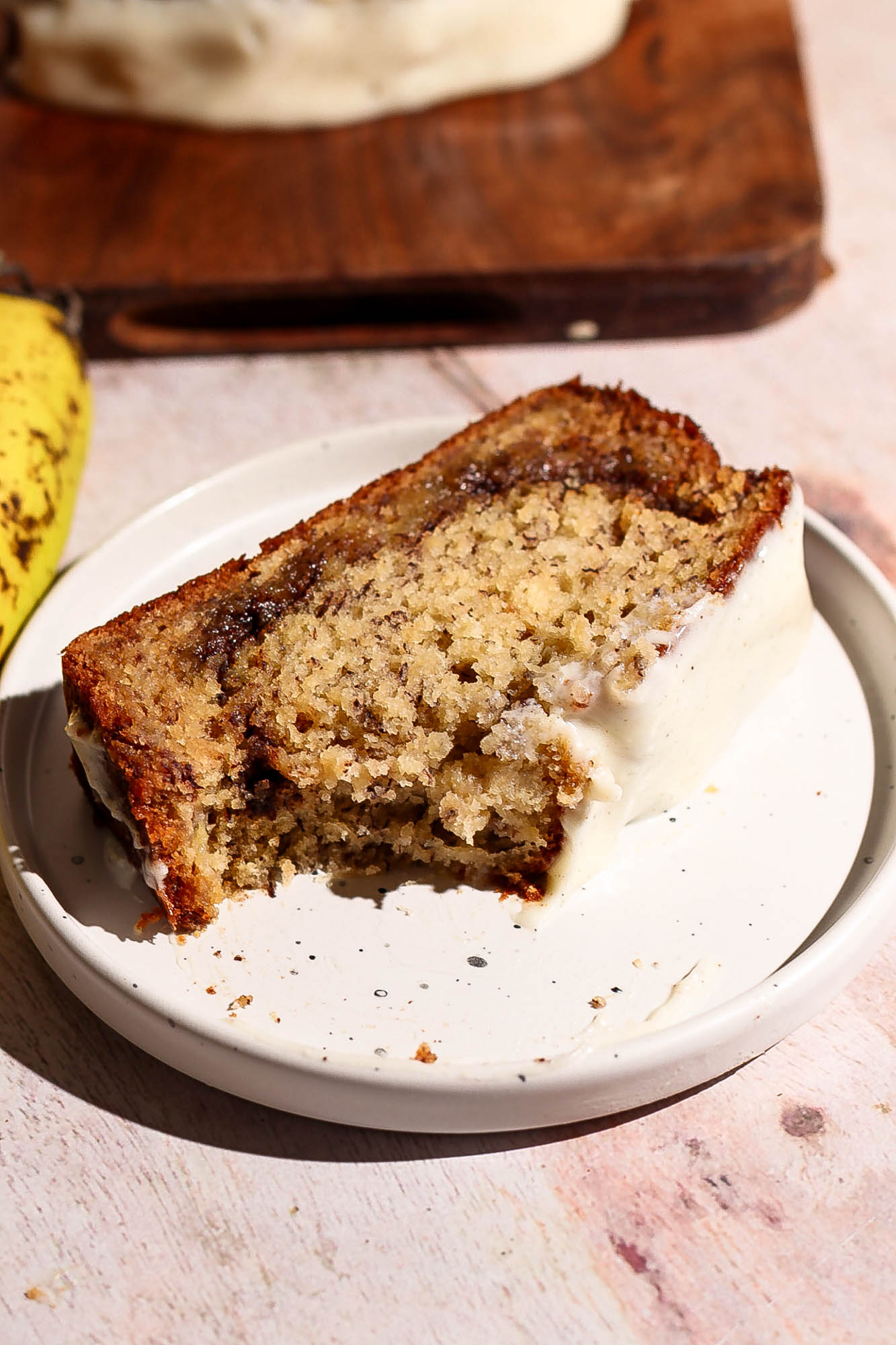 Slice of cinnamon roll banana bread on a plate.