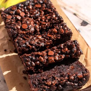 Double chocolate banana bread sliced on a brown parchment paper.