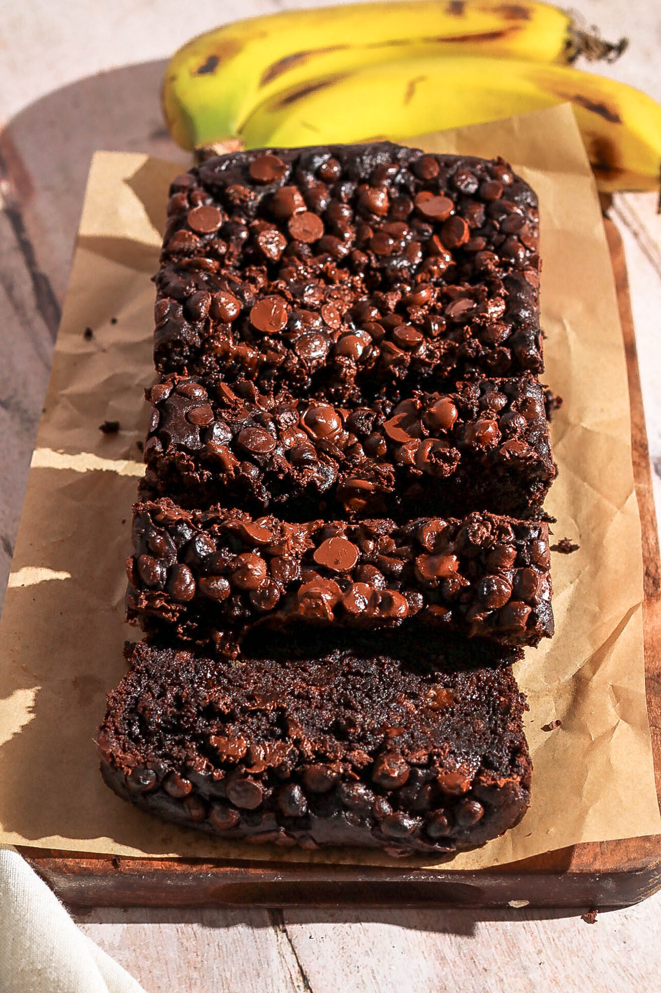 Slice double chocolate banana bread on a cutting board.