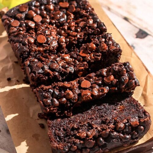 Double chocolate banana bread sliced on a brown parchment paper.