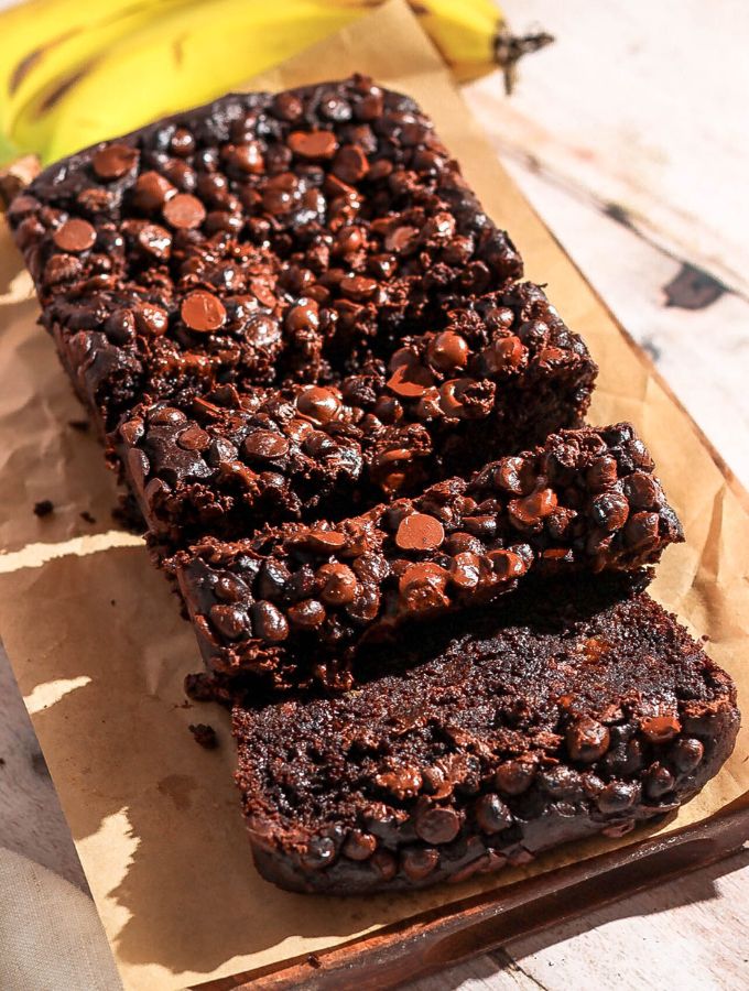 Double chocolate banana bread sliced on a brown parchment paper.